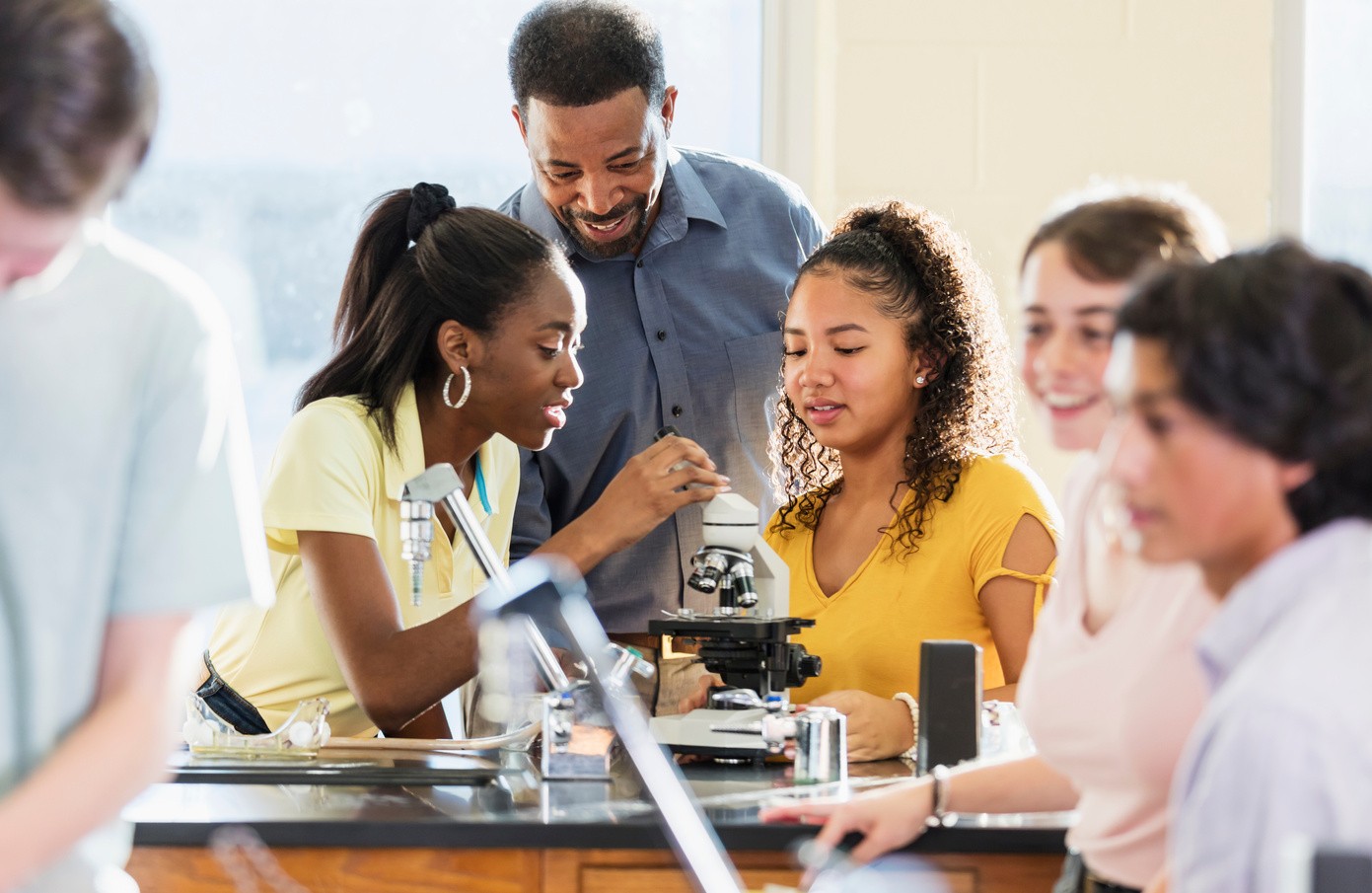 African-American man teaching high school science lab